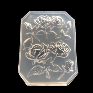 Macro detail of octagonal silicone mold featuring blooming rose and leaf patterns