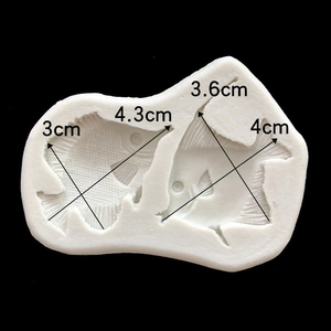 Macro view of white silicone mold featuring two tropical fish shapes with dimensions