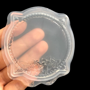 Close-up of translucent silicone mold with rose relief and bead frame for DIY resin