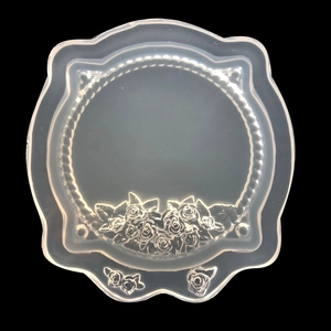 Detail showing translucent silicone mold with retro frame design and rose embossed patterns