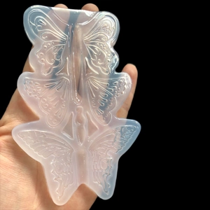 Detail view of translucent silicone butterfly mold with three various hollow patterns