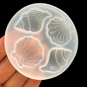 Macro detail of a translucent silicone mold featuring shell and conch designs for DIY resin