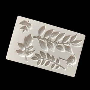 Detail of white silicone cake mold featuring intricate 3D rose and leaf textures