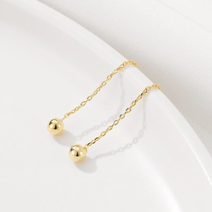 Boucles d'oreilles minimalistes en or 14K avec pendentifs boules dorées au fini miroir