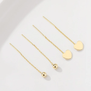 Boucles d'oreilles traversantes en or 14K avec pendentifs cœur et perle