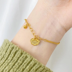 Detailed shot of adjustable 24K gold plated bracelet with traditional Ruyi lock charm