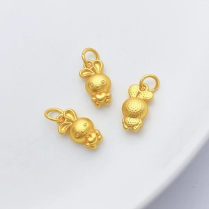Detailed macro view of three matte gold rabbit pendants for DIY jewelry making