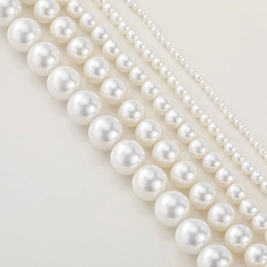 Macro detail of natural shell beads in five sizes with premium creamy white pearl luster