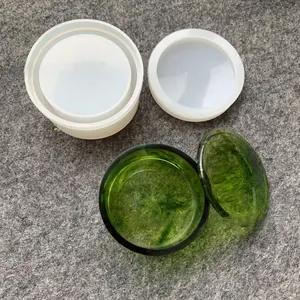 Detail of round silicone storage box mold with clear green resin finished product