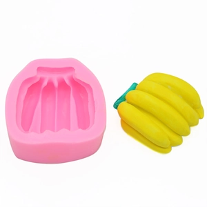 Detail of pink silicone banana mousse cake mold alongside finished yellow banana shape