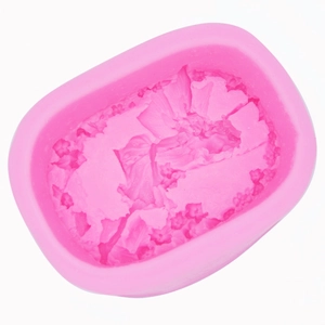 Detailed view of pink silicone mold with intricate floral and botanical relief patterns
