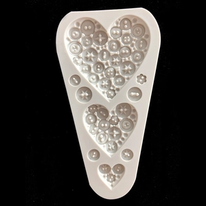Triangle silicone fondant mold featuring heart shapes with button and snowflake textures