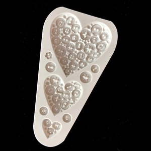 Macro view of heart-shaped button silicone mold with detailed star pattern relief
