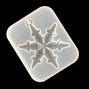 Detailed view of translucent snowflake silicone mold for DIY resin jewelry making
