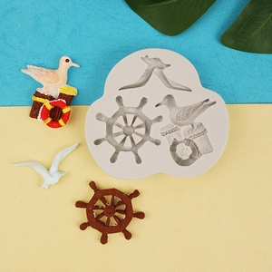 Macro detail of seagull and ship wheel silicone mold for fondant and cake decoration