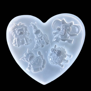 Macro detail of heart-shaped silicone mold featuring lion, elephant and animal shapes