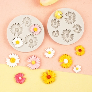 Daisy silicone mold set for DIY crafts with colorful resin flower samples on dual-tone background