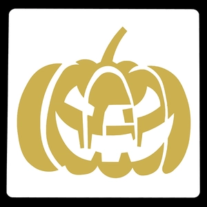 Macro detail of golden Halloween pumpkin stencil with hollowed-out carving patterns