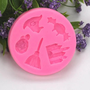 Pink silicone mold featuring Halloween shapes like a witch hat, pumpkin, and castle