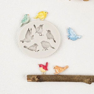 Round white silicone mold with five diverse bird shapes for fondant cake decoration