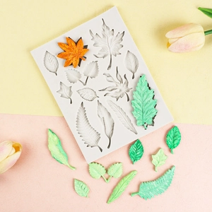 Macro detail of multi-cavity silicone mold with realistic maple and fern leaf textures