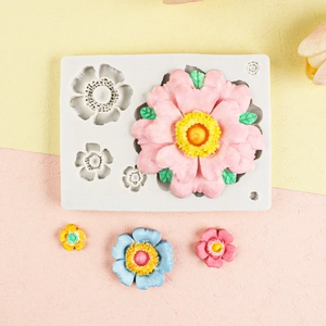 Detailed macro view of white silicone mold featuring 3D floral cavities with pink flowers