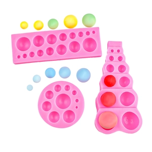 Pink silicone mold set for chocolate spheres and round dessert decorations on white base