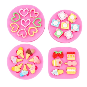 Pink silicone mold set featuring camera, heart, ice cream and dessert shapes for DIY crafts