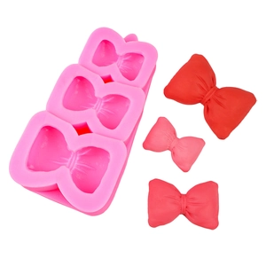 Pink silicone mold for bow-shaped cupcake toppers and fondant chocolate decorations
