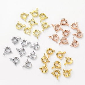 Close-up of four-color 14K gold-filled spring ring clasps for DIY jewelry making