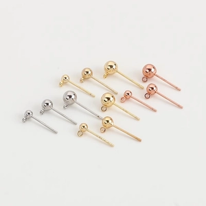 Detailed close-up of DIY gold and silver round ball stud earring posts with hanging rings