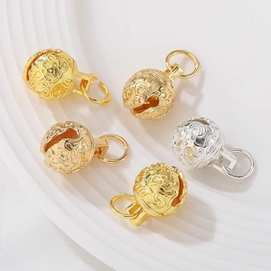 Macro shot of 14K gold-plated hollow bell pendants for DIY jewelry and necklaces