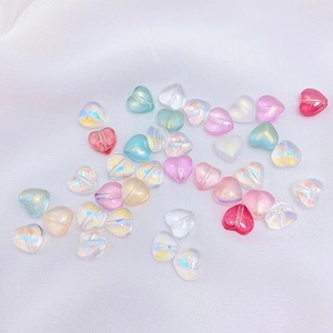 Macro view of 8mm iridescent heart glass beads for DIY jewelry making and crafting