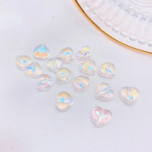 Macro detail of 8mm heart-shaped Czech glass beads with aurora iridescent finish