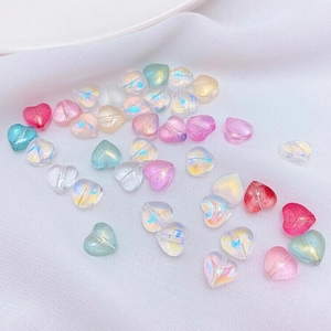 Detailed macro view of 8mm translucent heart-shaped Czech glass beads for DIY jewelry