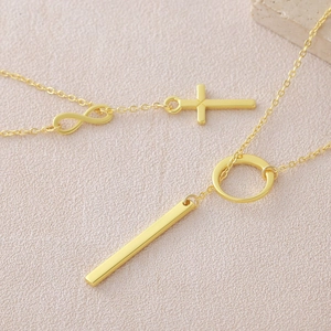 Gold layered necklace with infinity symbol cross pendant and rectangular metal bar