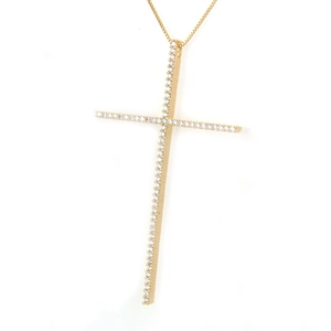Detailed view of large gold cross pendant featuring shimmering zircon pavé stones