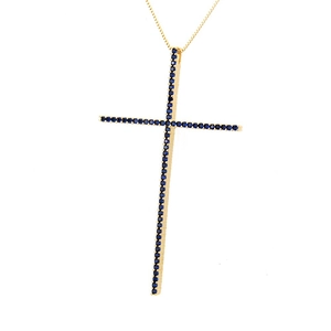 Close-up of golden cross pendant featuring micro-pave dark blue zircon stones