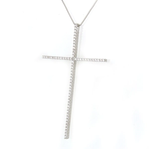 Macro detail of silver cross pendant with shimmering cubic zirconia and box chain