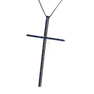 Macro shot of long cross pendant with pavé blue zircons and black plated box chain
