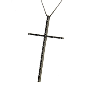 Detail of cross necklace featuring black zircon pavé settings on a long pendant