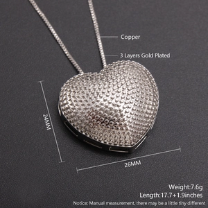 Macro detail of silver plated heart pendant showing dimensions and copper material base