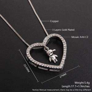 Macro view of hollow heart pendant necklace with AAA zirconia and moving cartoon figure