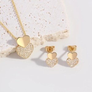 18k gold plated jewelry set featuring layered solid heart and zircon pavé heart pendants