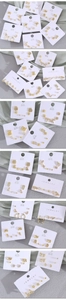 Detailed view of assorted gold animal stud earrings with zircon on a jewelry card