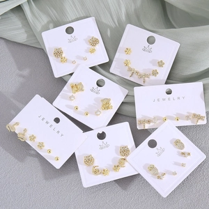 Golden stud earring set with zircon animal shapes like dragonflies and owls on card
