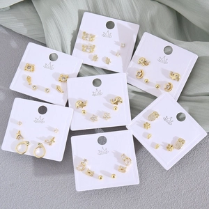 Gold animal stud earring sets with zircon accents on white display cards