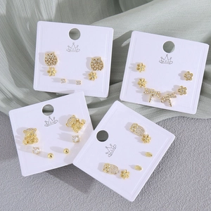 Golden stud earring set with zircons featuring animal, floral, and minimalist designs