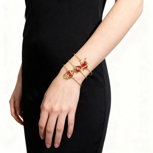 Elegant multi-layer gold bracelet featuring red heart crown pendants on female wrist