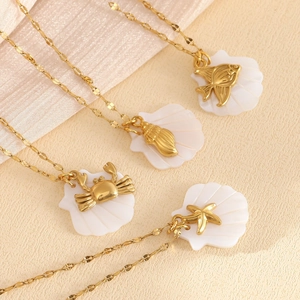 Gold plated ocean shell necklaces featuring starfish, crab, and conch charms for summer beach